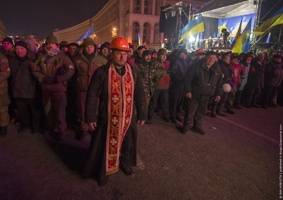 16. A priest stands first in row of the human shield in Kiev