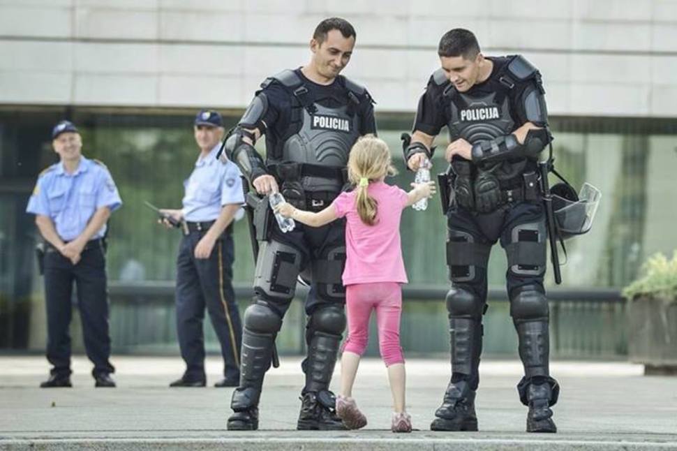 5. Girl gives water to 2 officers in Bosnia