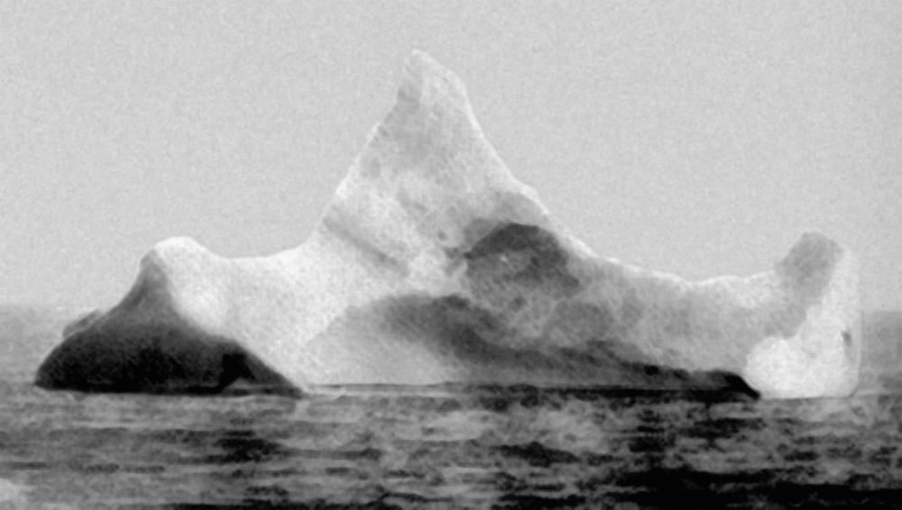 The iceberg to the right is the one that is claimed to have hit the Titanic. It has a red streak of paint and dent fit