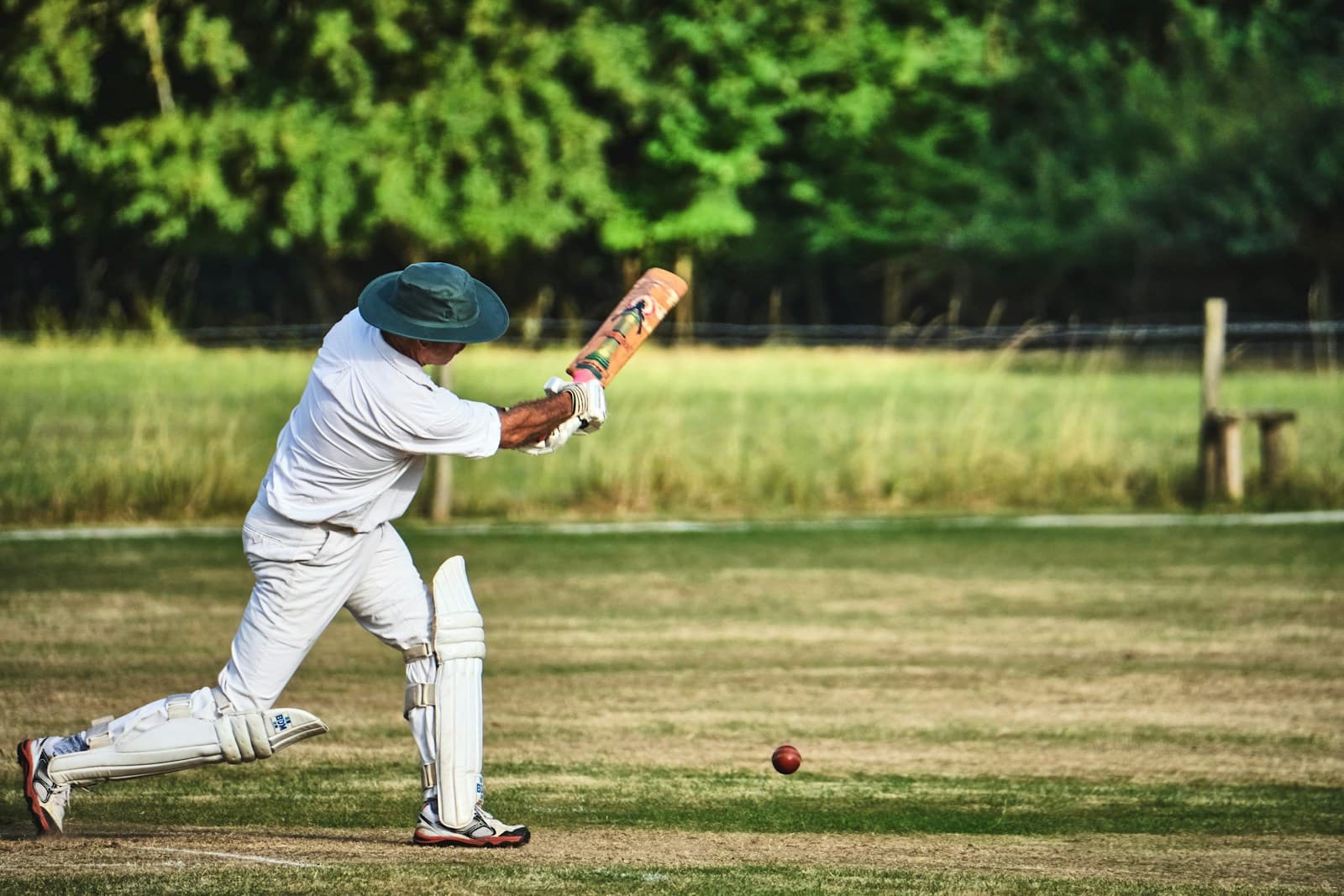 man in white pants and blue baseball mitt holding baseball bat during daytime