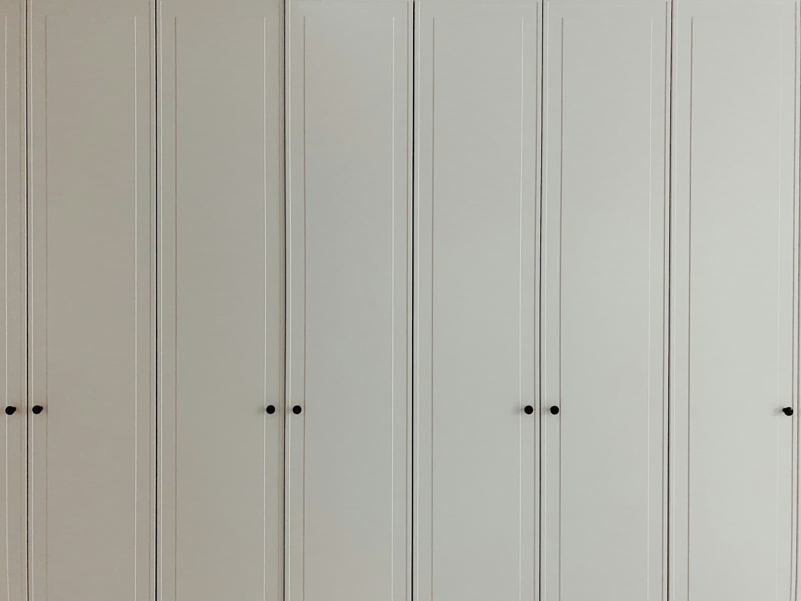 a room with a bunch of white cupboards