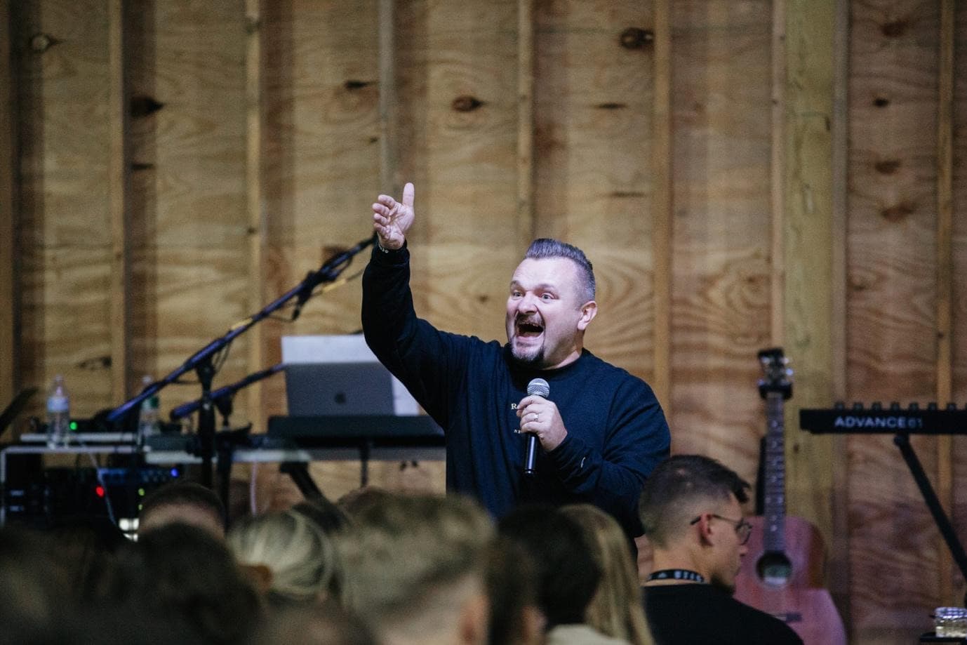 Entertainer holding a microphone and interacting with a live audience at an interactive show