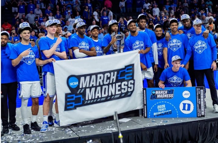 College basketball team celebrating with an NCAA March Madness banner