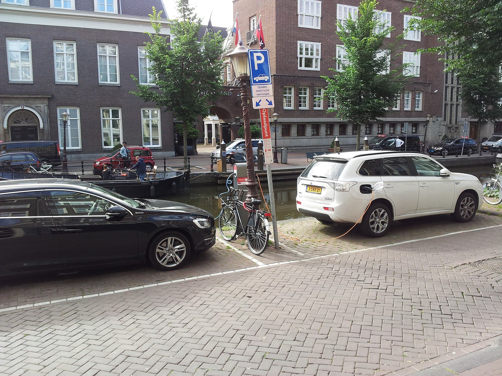 Electric vehicles plugged into a public charging station