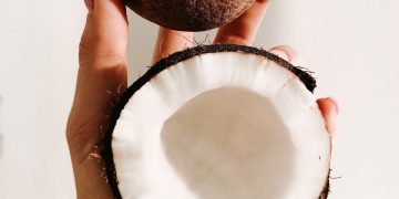 person holding white and black round ornament