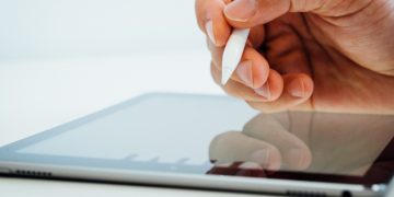 person holding white stylus pen