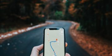 person holding white iphone 5 c