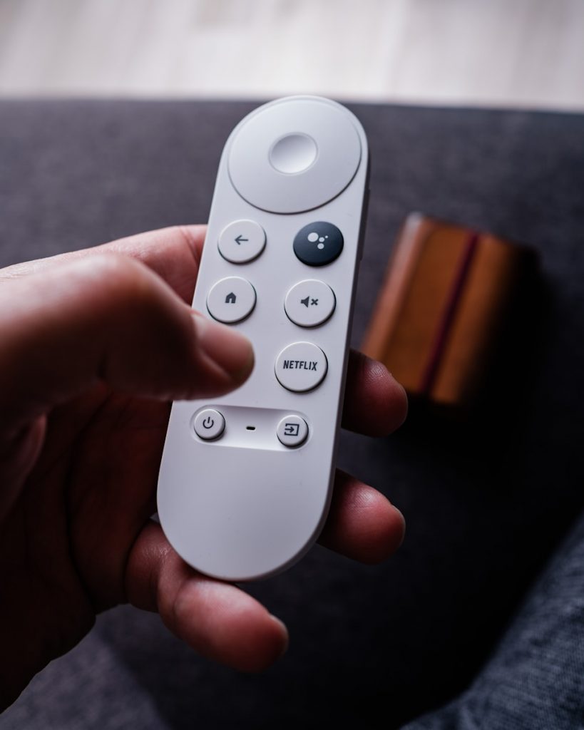 a person holding a remote control in their hand