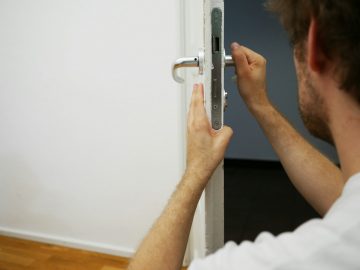 person holds door lever