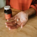 person holding medication pill