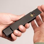 a person holding a black object in their hand