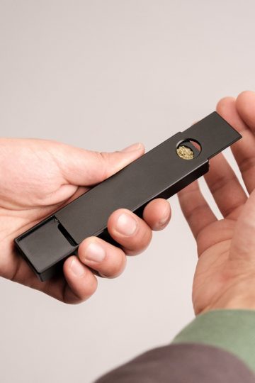 a person holding a black object in their hand