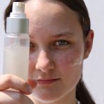 a woman holding a bottle