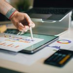 a person is writing on a piece of paper