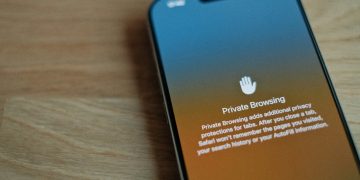 A cell phone sitting on top of a wooden table