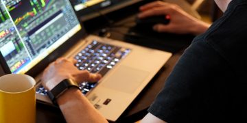 man sitting in front of the laptop