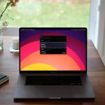 a laptop computer sitting on top of a wooden desk