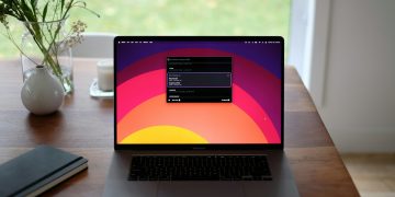 a laptop computer sitting on top of a wooden desk