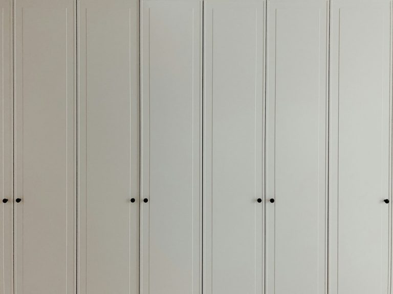 a room with a bunch of white cupboards