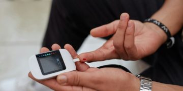 a person blood glucose testing using gluco-meter