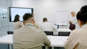 Business people in a modern conference room during a presentation.