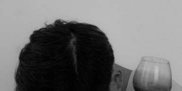 a woman with a glass of wine