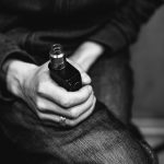 a person holding a bottle of alcohol in their hand