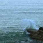 brown rock formation on sea during daytime