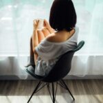 woman in white tank top sitting on chair